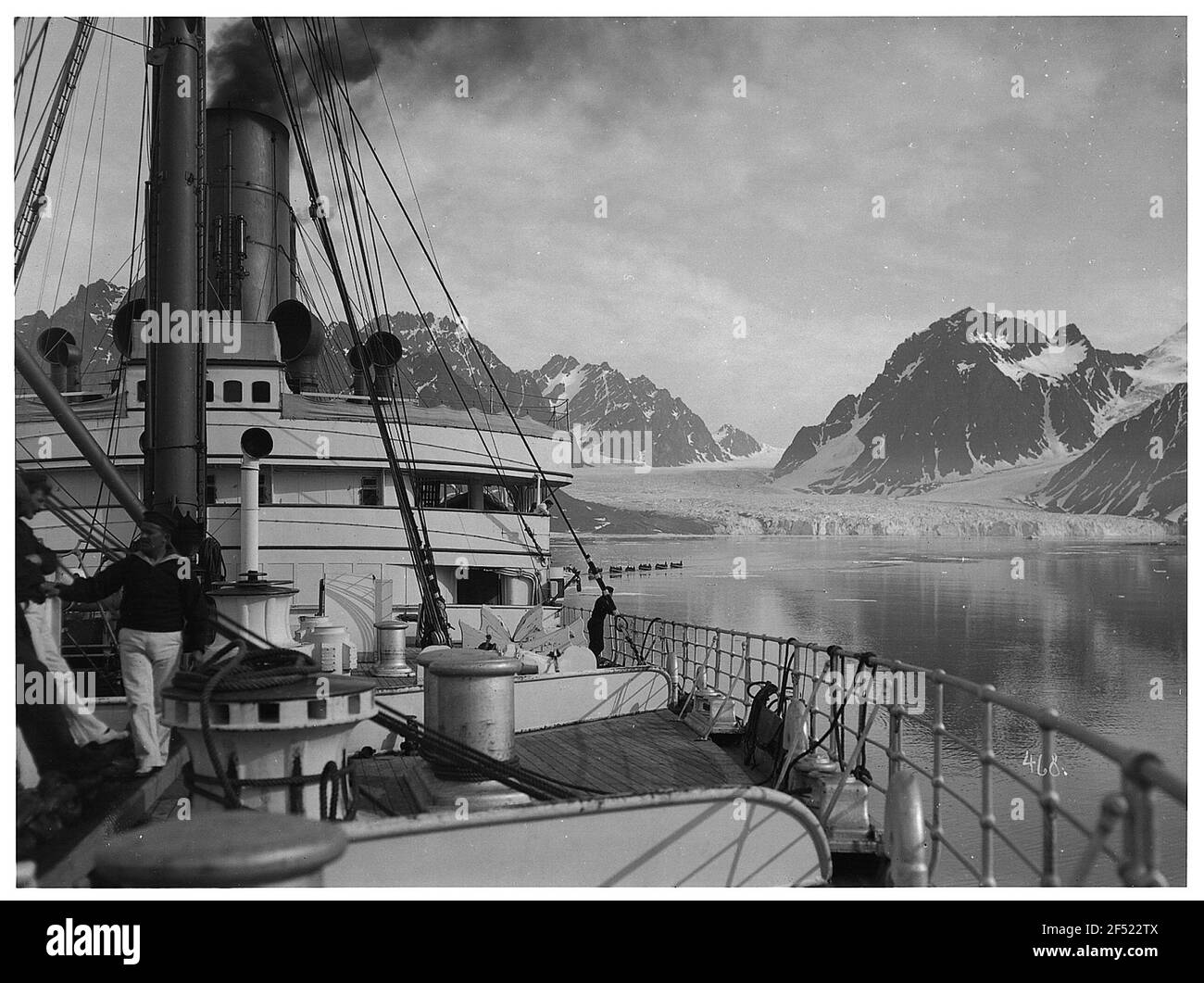 Spitzbergen, Norvège. Crossbay. Vue le long de la forepette du bateau à vapeur haute mer 'Victoria Luise' avec des marins contre les glaciers et les montagnes du Kreutzbucht et Boatskorso avec les touristes du débarquement Banque D'Images