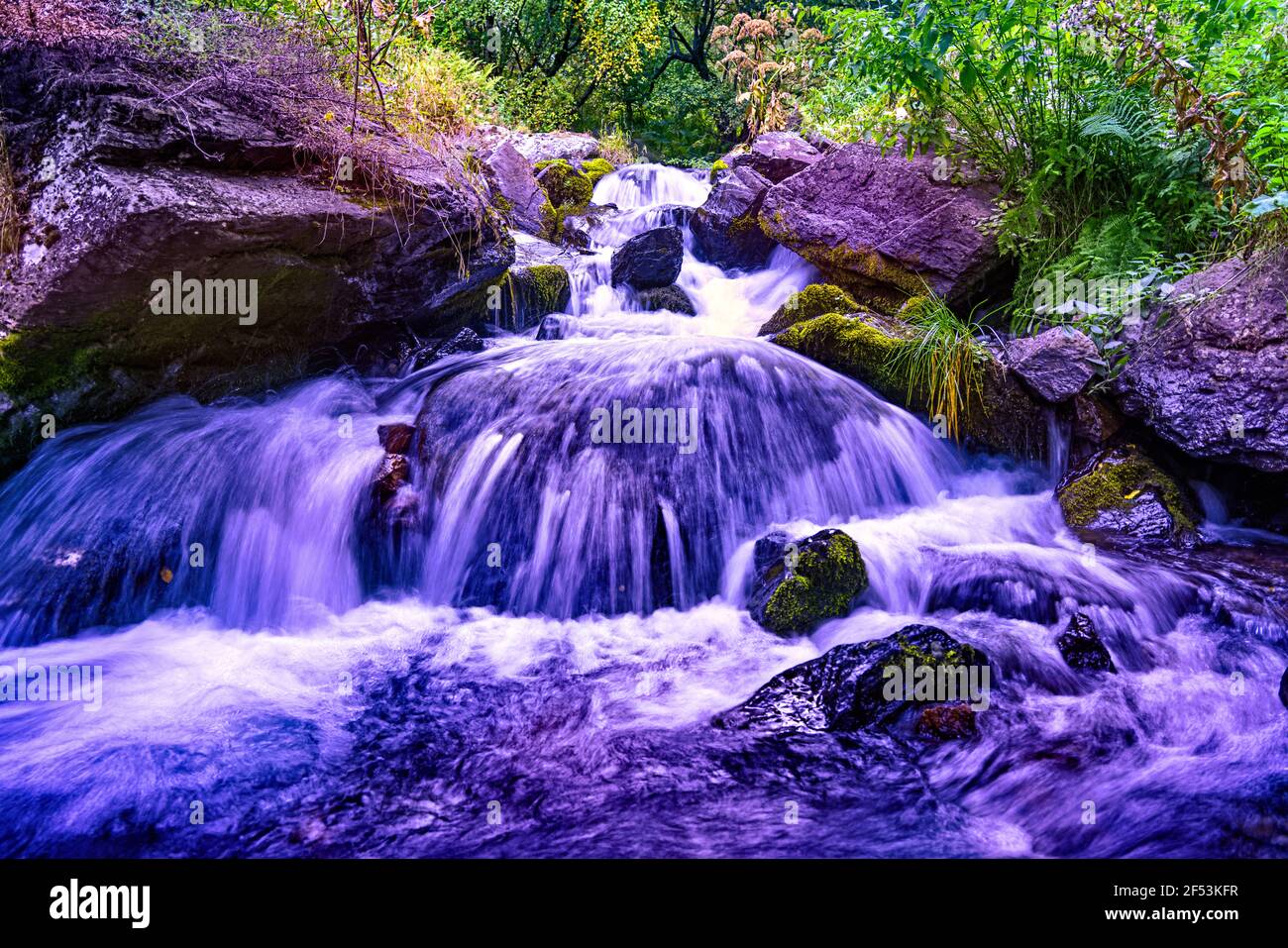 La rivière de montagne bleue coule entre les pierres Banque D'Images