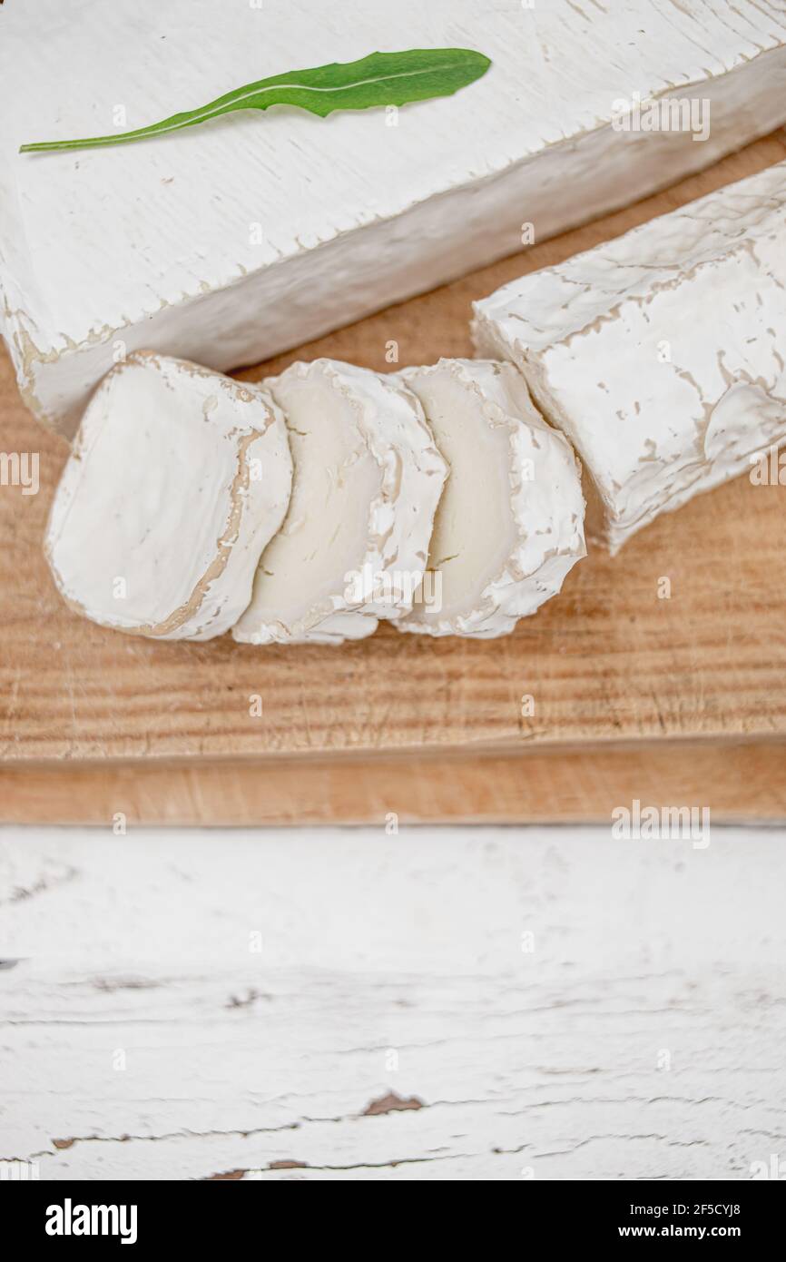 Fromage frais sur bois sur fond blanc. Plateau de fromages Banque D'Images