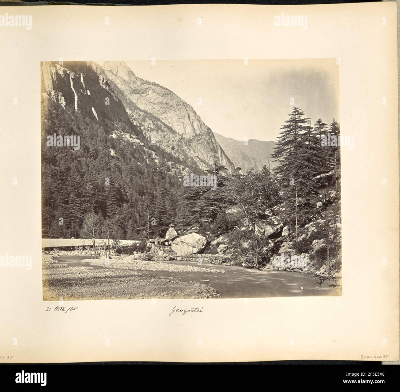 Gangootri. Vue sur la rivière Bhagirathi à Gangotri. Un bâtiment en pierre est visible sur la rive opposée de la rivière, et une clôture de branches d'arbres est écrasée ensemble pour créer un mur de support retient les pierres à droite de la structure. Les arbres couvrent les flancs de montagne en pente. (Recto, mount) en bas à gauche, manuscrit à l'encre noire: '21 octr /65' en bas à gauche, manuscrit à l'encre noire: 'A42.35 (Bou)' en bas au centre, manuscrit à l'encre noire: 'Gangootri' Banque D'Images