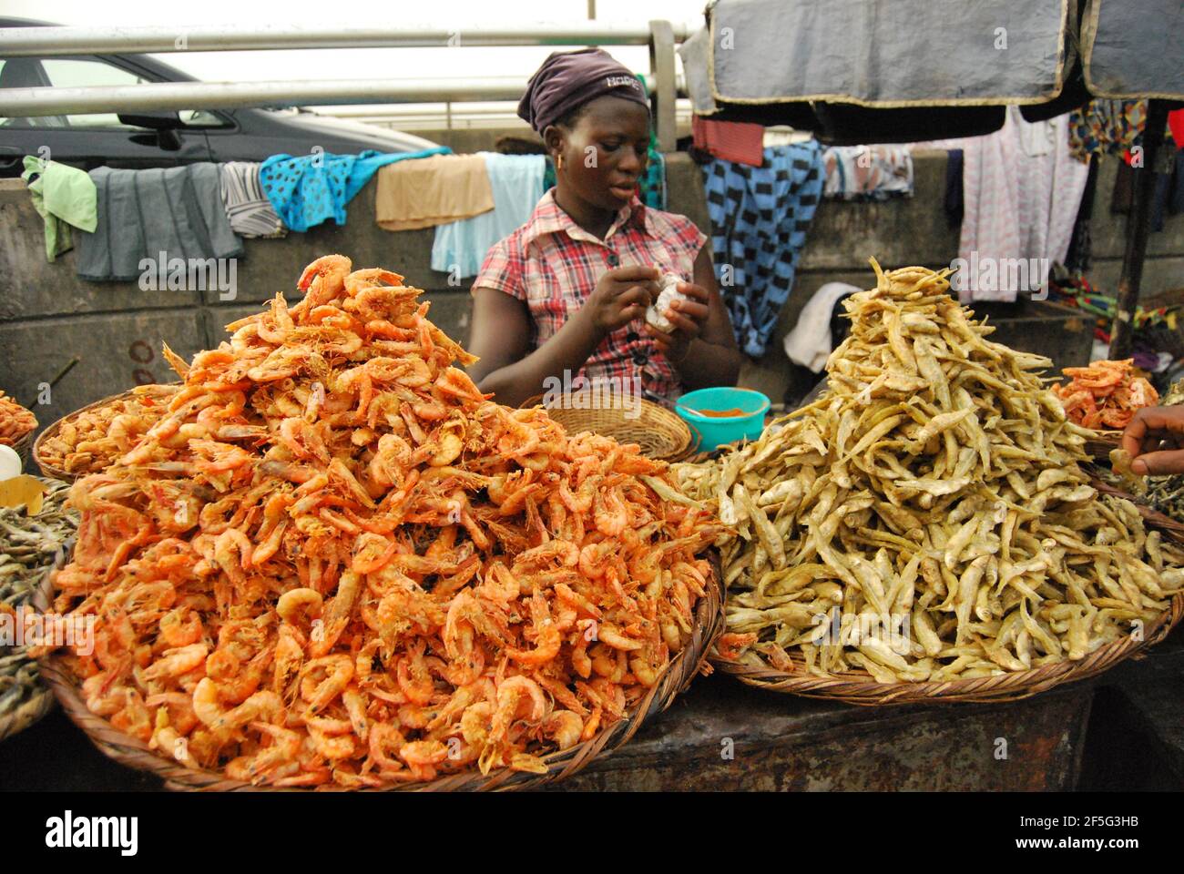 Une femme qui vend des écrevisses dans une rue de Lagos, au Nigeria. Banque D'Images