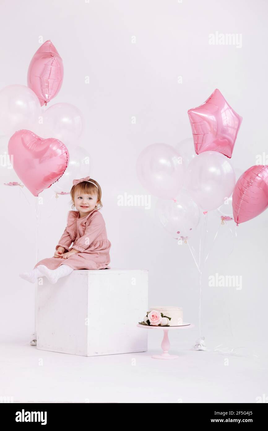 Joyeux Anniversaire 2 Ans Petite Fille En Robe Rose Gateau Blanc Avec Bougies Et Roses Decorations D Anniversaire Avec Ballons Blancs Et Roses Et C Photo Stock Alamy