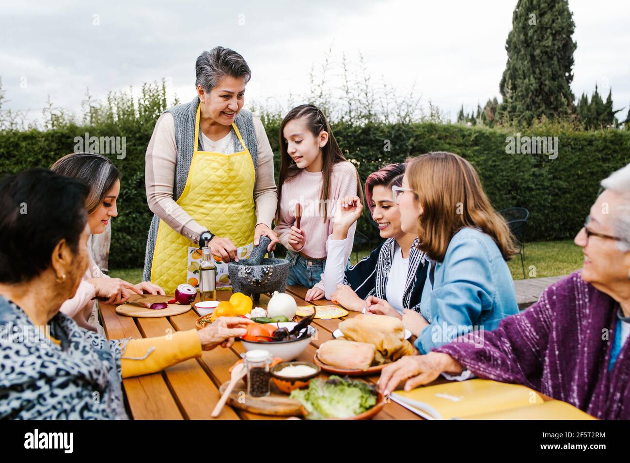 Grand-mère latine et petite-fille, fille qui cuisine la nourriture mexicaine à la maison, trois générations de femmes au Mexique Banque D'Images