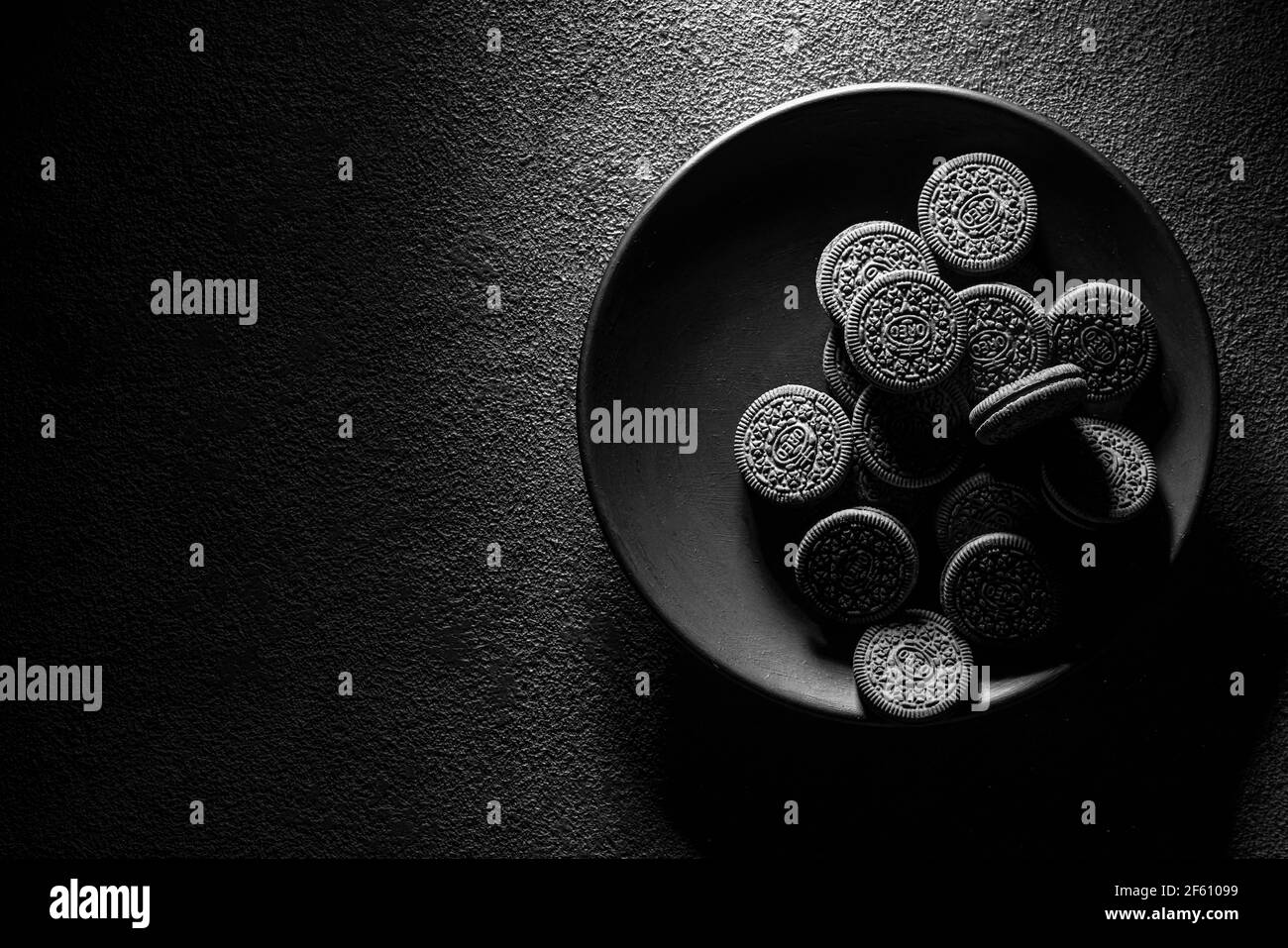 KRASNOYARSK, RUSSIE, 9 février 2020 : biscuits oreiro noirs en gros plan dans une assiette, vue du dessus. Arrière-plan texturé sombre. Banque D'Images