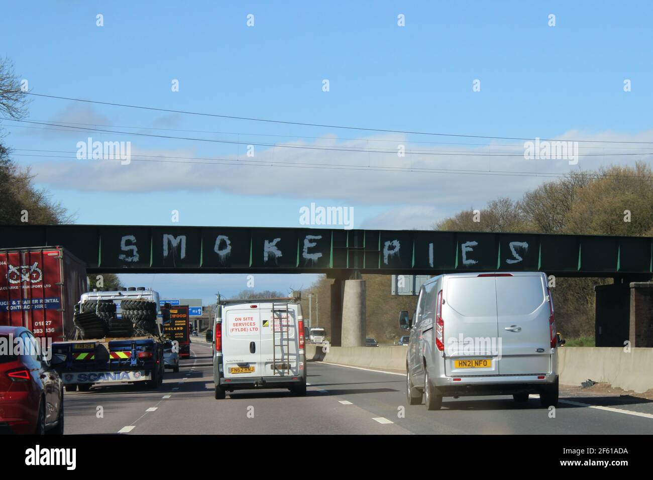 Des tourtes de fumée peintes en blanc sur le pont entre la jonction 18 et 19 de l'autoroute M6 en référence à la bande de Liverpool. Concept de graffiti de pont Banque D'Images