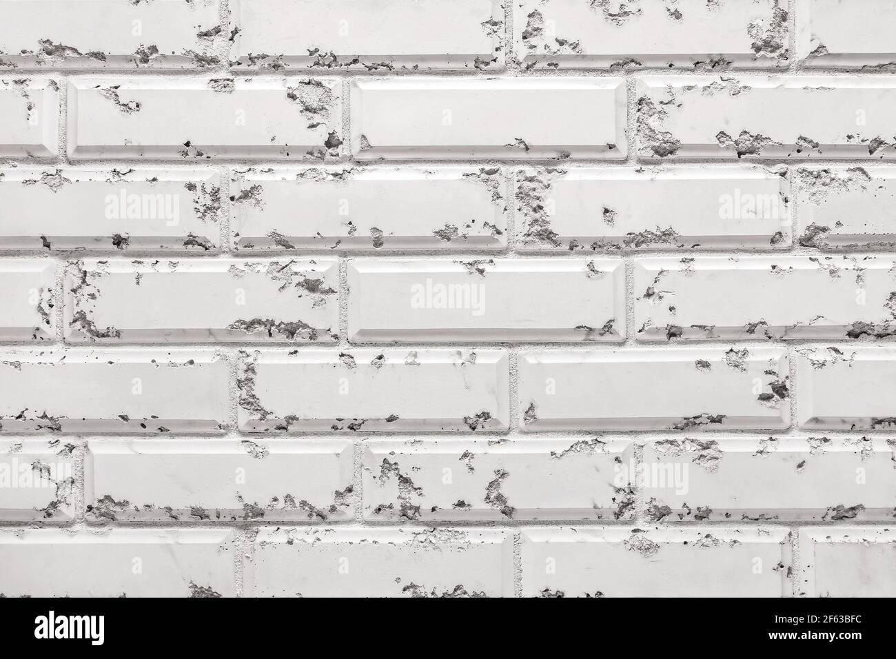 Texture d'un mur en brique blanc décoratif avec arrière-plan de motifs abstraits. Banque D'Images