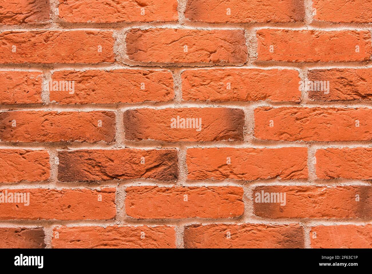 Texture de mur de briques décoratif orange ou brun avec fond de motif de fissures. Banque D'Images