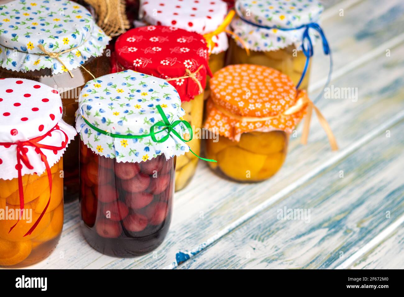 Compote fruitée. Plats maison conservés dans un pot sur une table en bois blanc. Variété de compotes de fruits Banque D'Images