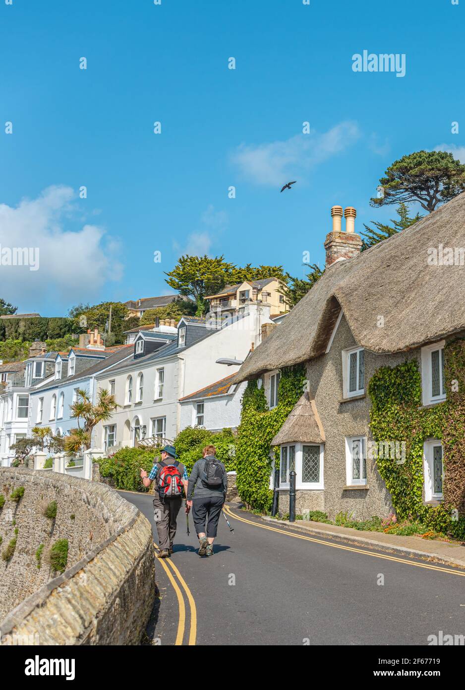 Randonneur dans une rue côtière au village de St.Mawes, Cornouailles, Angleterre, Royaume-Uni Banque D'Images