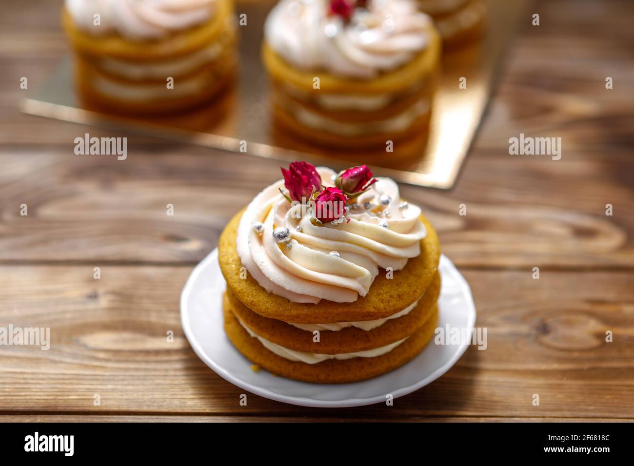 Gâteau éponge à la crème, décoré de petites fleurs. Le concept d'une friandise festive. Banque D'Images