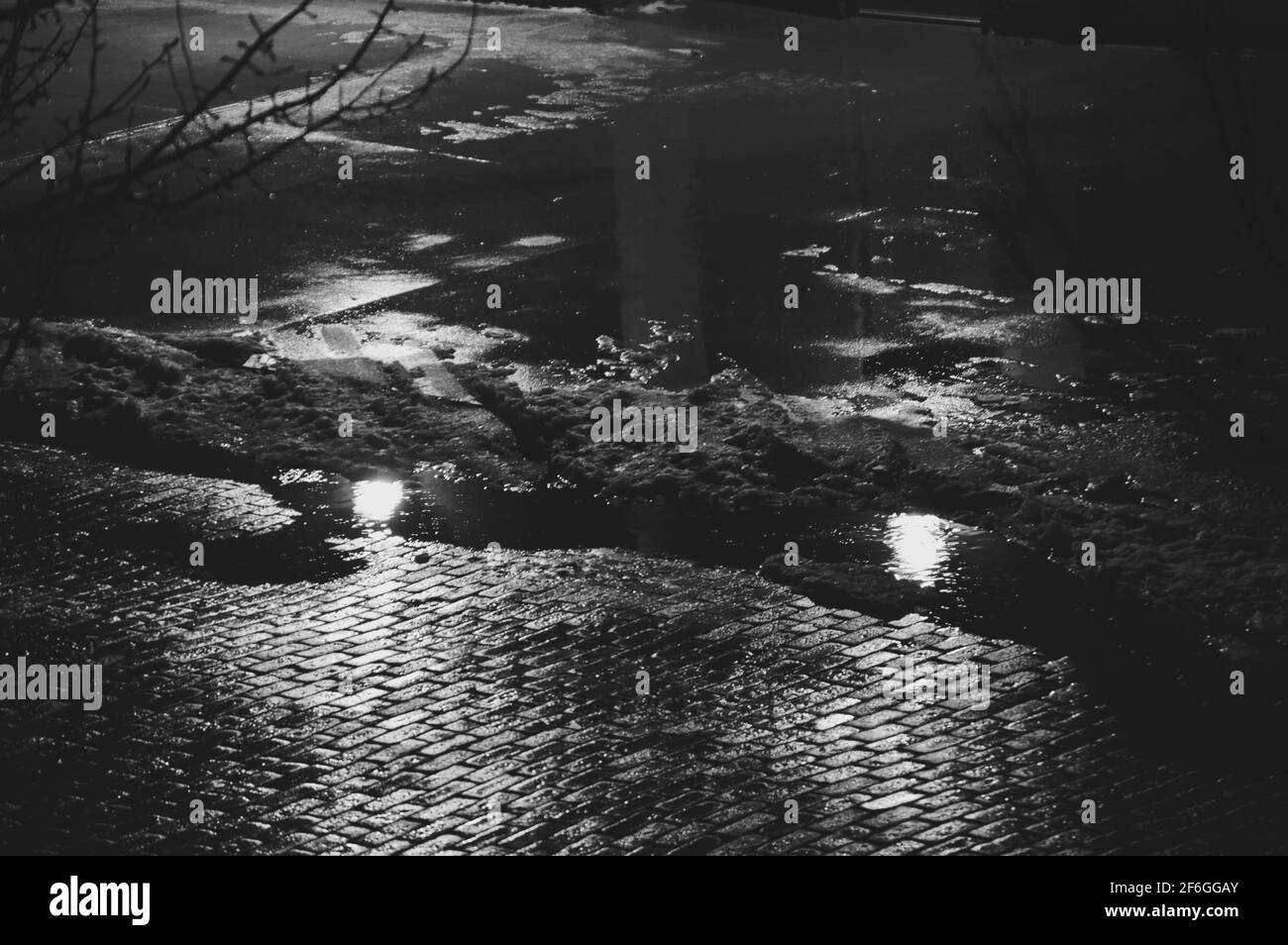 Trottoir en briques dans la pluie la nuit Banque D'Images
