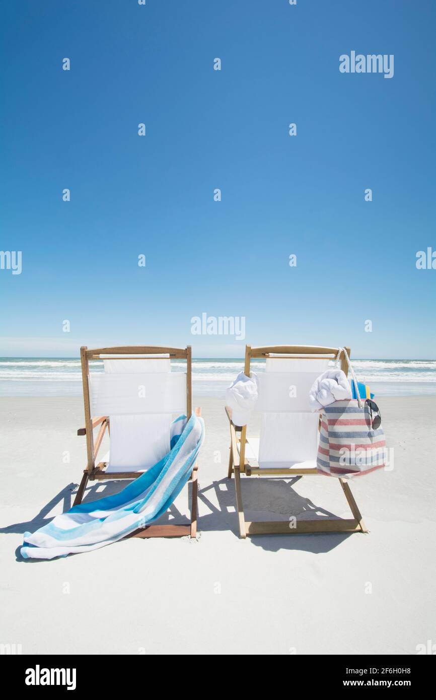 Vider les chaises de plage avec un sac et une serviette sur la plage Banque D'Images