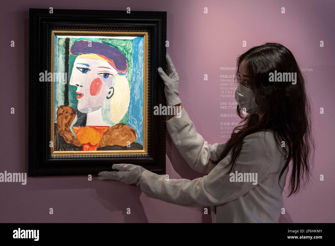 Hong Kong, Hong Kong, Chine. 18 décembre 2020. Cristina Wang, spécialiste de l'art moderne et contemporain, ajuste le tableau « Femme au Béret mauve » de Pablo Picasso exposé à la Bonham Gallery à Admiralty Hong Kong en vue de sa vente à New York en mai 2021. La peinture de la plus grande muse de Picasso Mare-ThérÃ¨se Walter est en tournée mondiale pour attirer les acheteurs ayant été à Londres et Paris devant Hong Kong. Un prix de 15 millions de dollars US est estimé pour le chef-d'œuvre. Crédit : Jayne Russell/ZUMA Wire/Alay Live News Banque D'Images