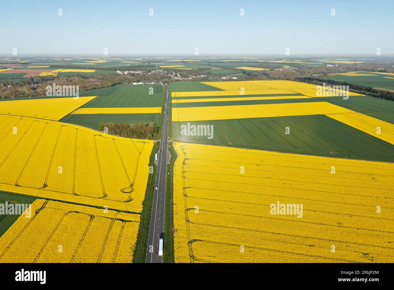 Photographie aérienne des champs de colza de Beauce avec la route nationale, ville de Gué-de-Longroi, département de l'Eure-et-Loir dans le centre-Val de Loire regio Banque D'Images