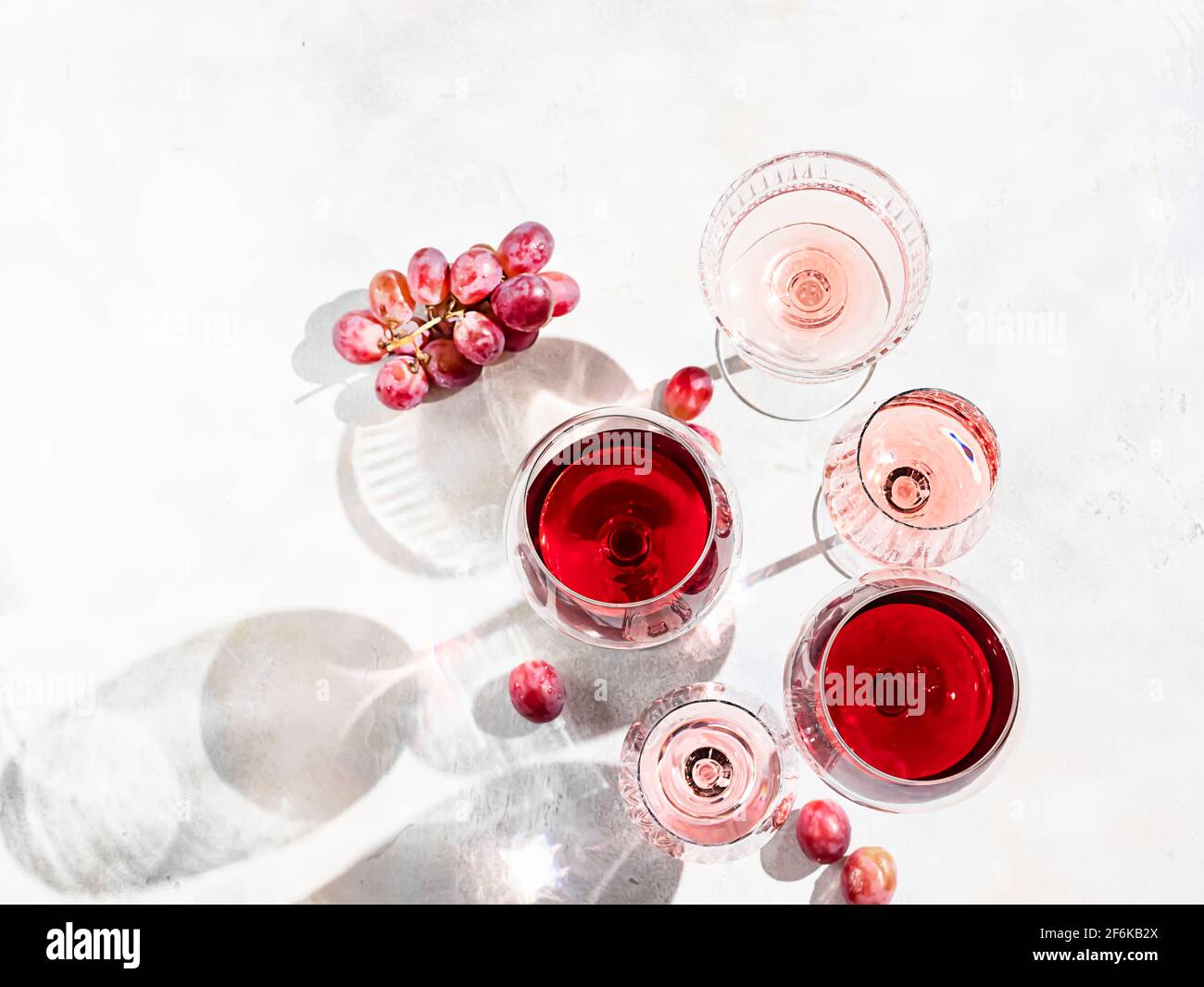 Vin de différentes variétés sur fond de béton léger. De nombreux verres de vin différents. Concept de dégustation de vins. Vue de dessus, plan d'appartement Banque D'Images