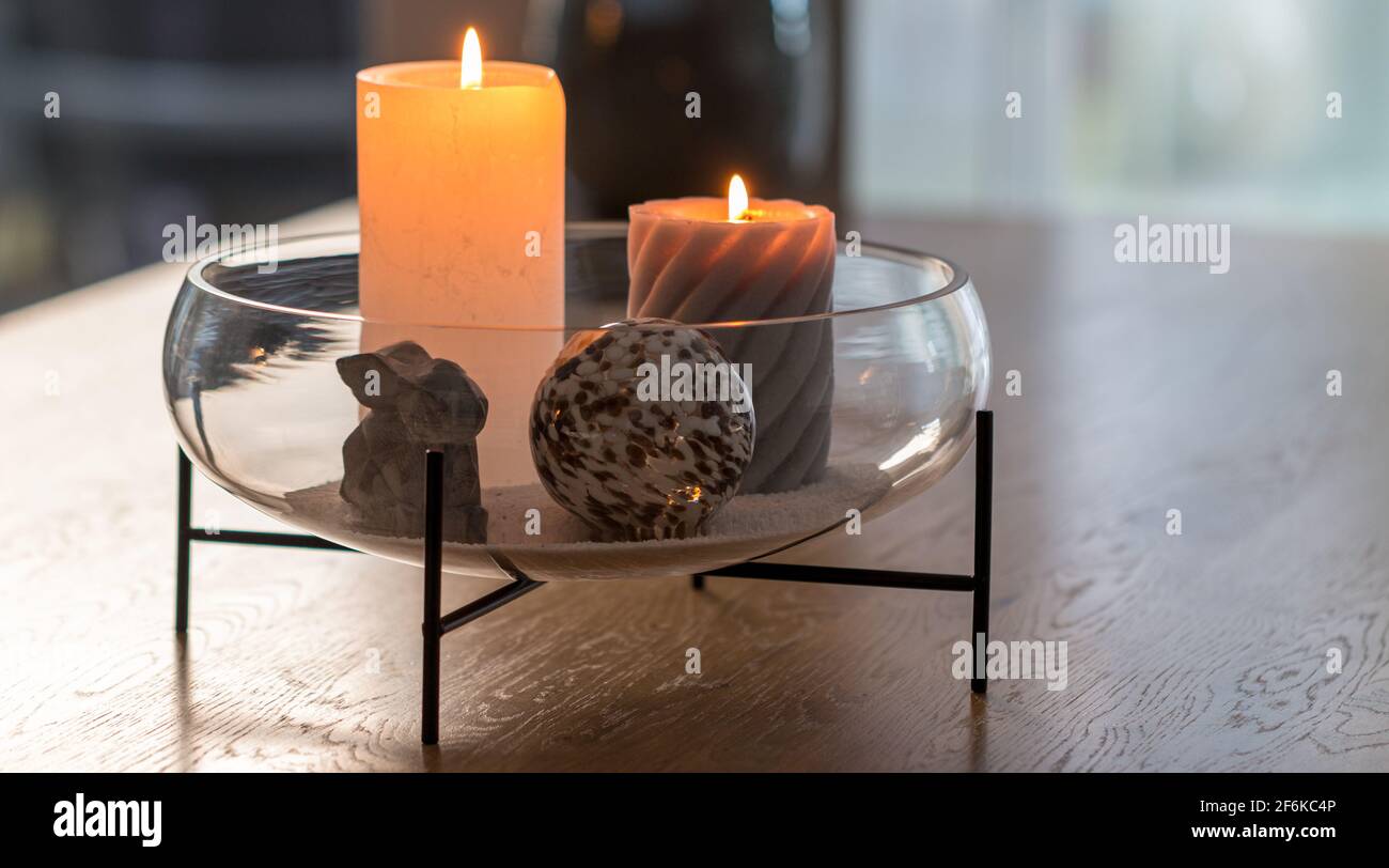 Bol décoratif en verre avec bougies, boule et lapin Banque D'Images