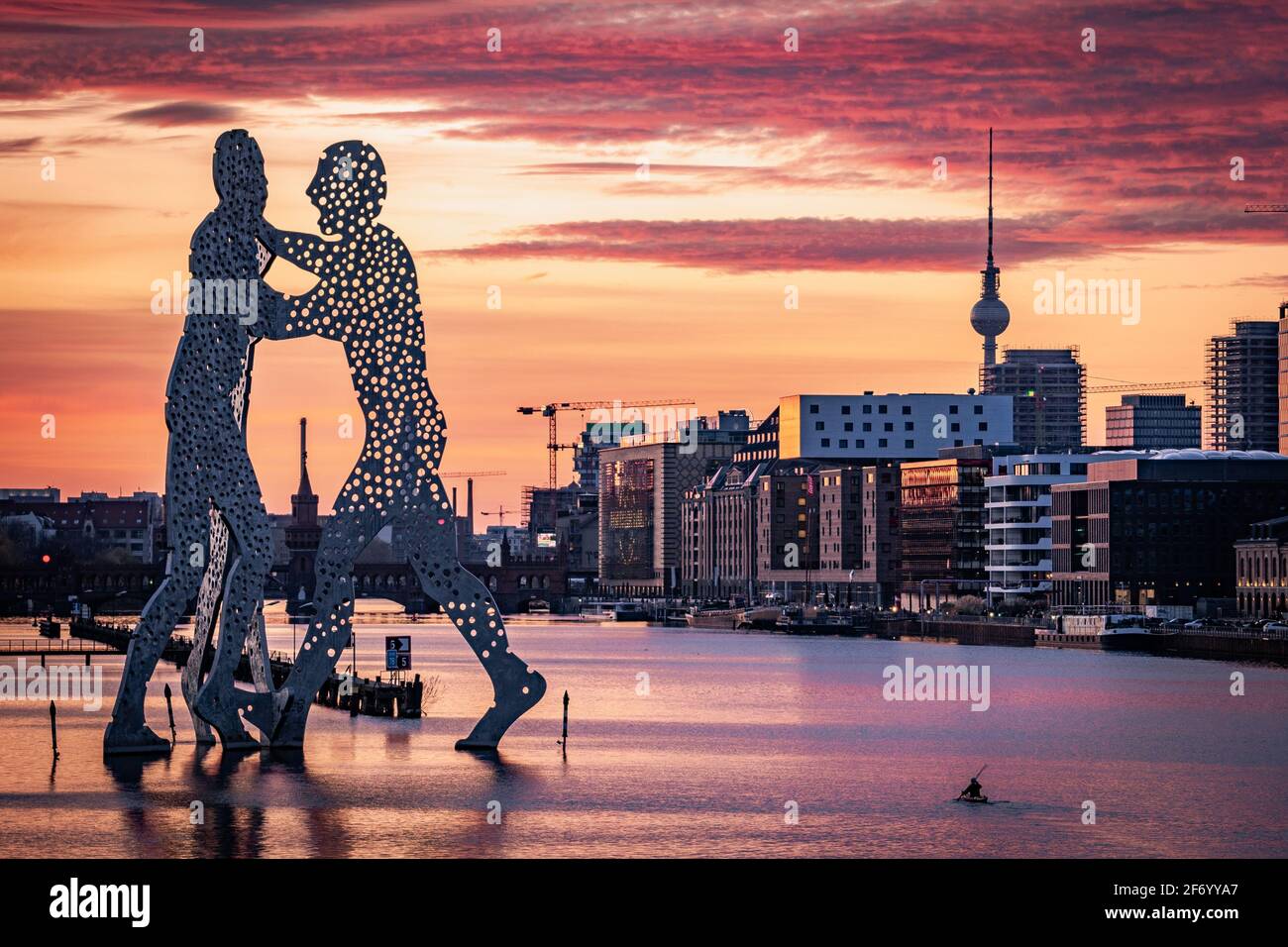 personne pagayant avec canoë en purée à côté de la statue de Molecule Man et vue sur la tour de télévision de berlin et oberbaum pont Banque D'Images