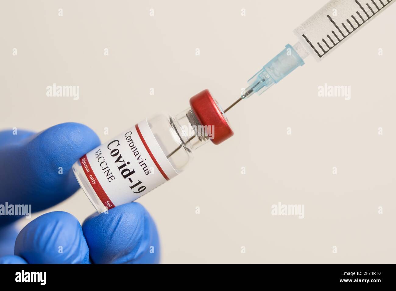 Médecin tenant le vaccin du coronavirus et la seringue utilisée pour prévenir l'infection par le COVID-19. Banque D'Images