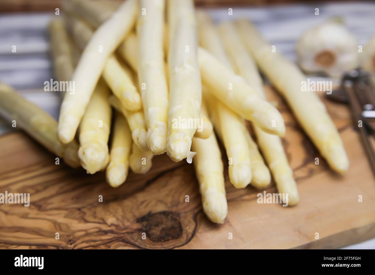 Gros plan sur des épis d'asperges blancs non cuits et crus isolés table en bois Banque D'Images