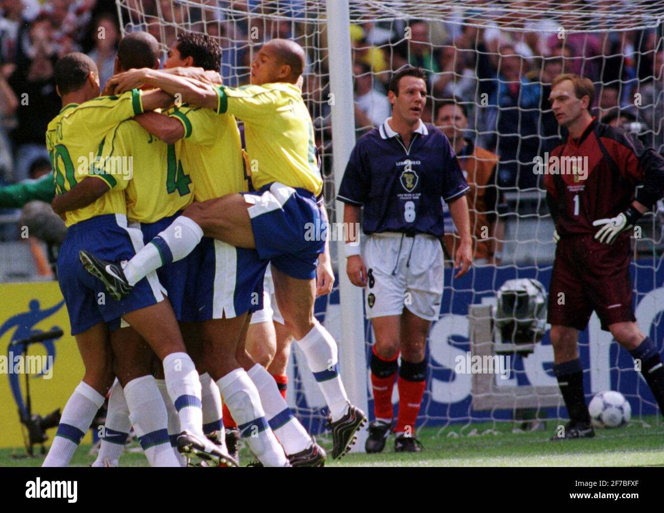 Cafu Brazil fête après avoir obtenu son score contre l'Ecosse du 1998 juin Le match d'ouverture de la coupe du monde à Paris à Le Stade de France comme défenseur de l'Ecosse Tommy Boyd et Le gardien de but Jim Leighton regarde Banque D'Images