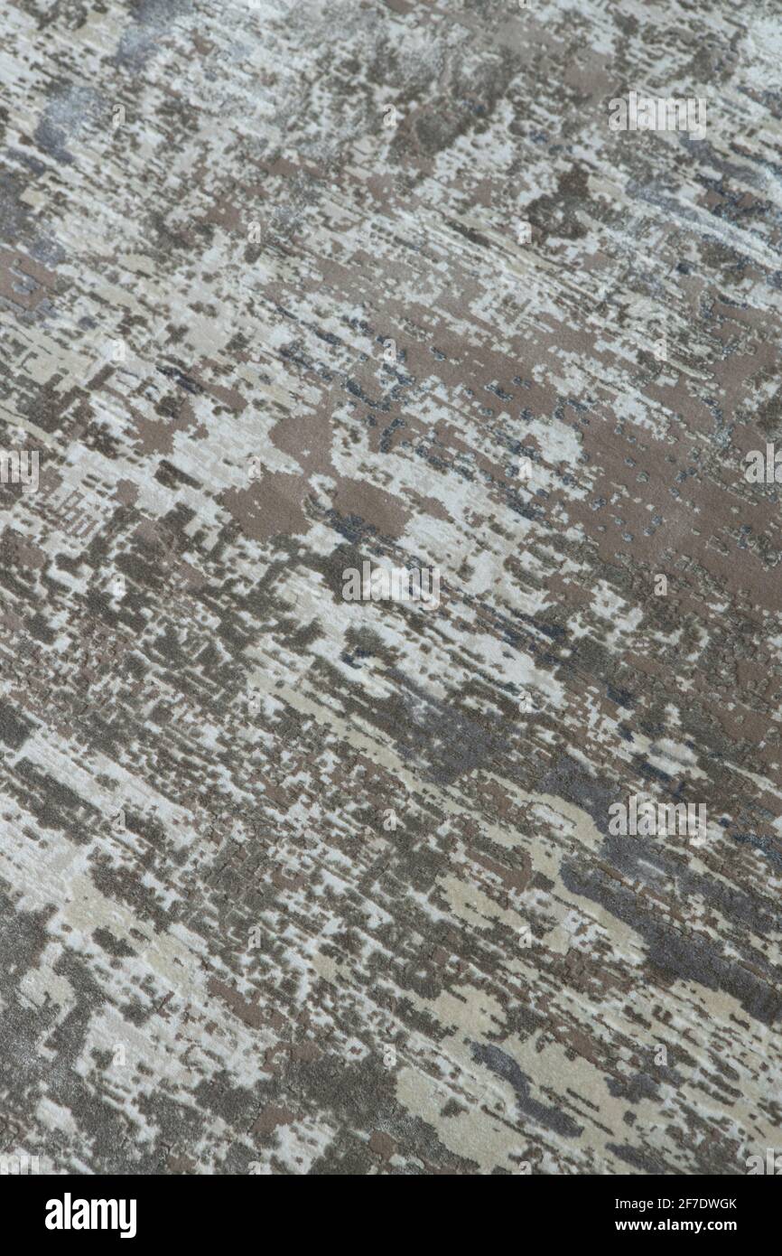Arrière-plan d'une élégante moquette dans des tons gris-beige neutres avec effet de décoloration et d'antiquité artificielle. Détails du concept d'un intérieur tendance, c Banque D'Images