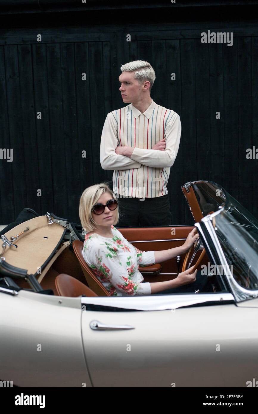 Un jeune couple stationné sur le côté et un homme debout près de leur cabriolet, 1964 Jaguar E Type série 1 Roadster, East Sussex, Royaume-Uni Banque D'Images