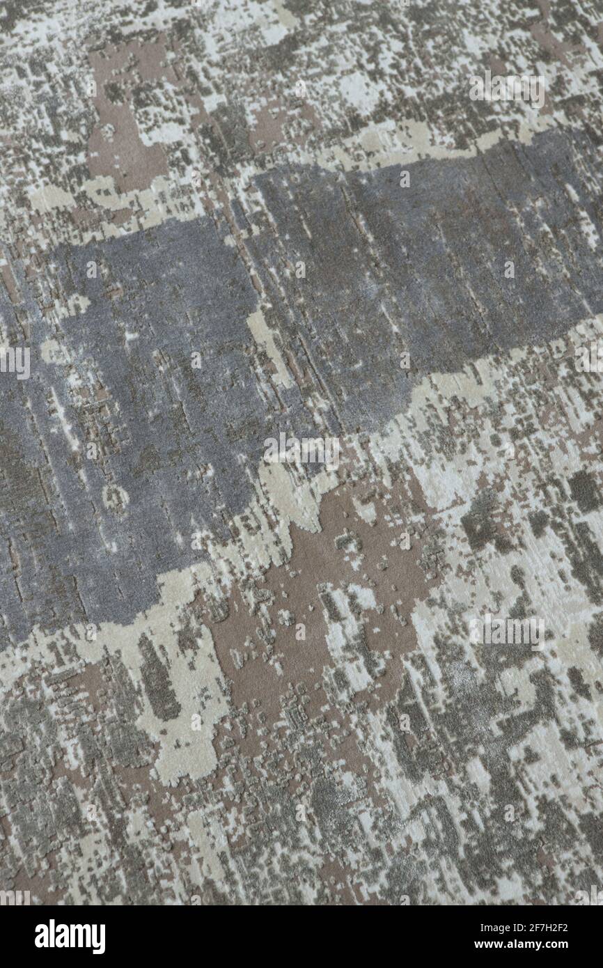Arrière-plan d'une élégante moquette dans des tons gris-beige neutres avec effet de décoloration et d'antiquité artificielle. Détails du concept d'un intérieur tendance, c Banque D'Images