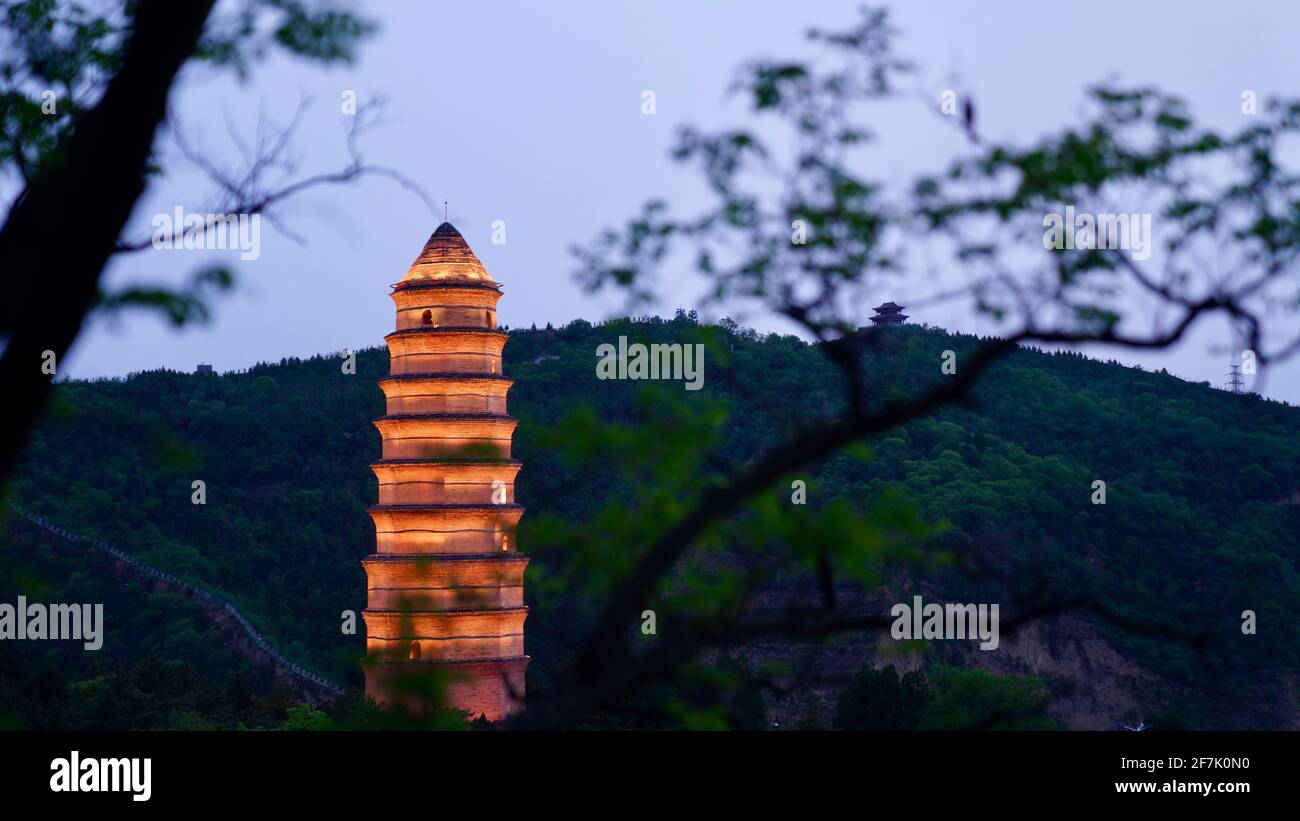 Une pagode de plusieurs étages à Yanan, debout sur les montagnes avec des lumières allumées pendant la nuit. Banque D'Images