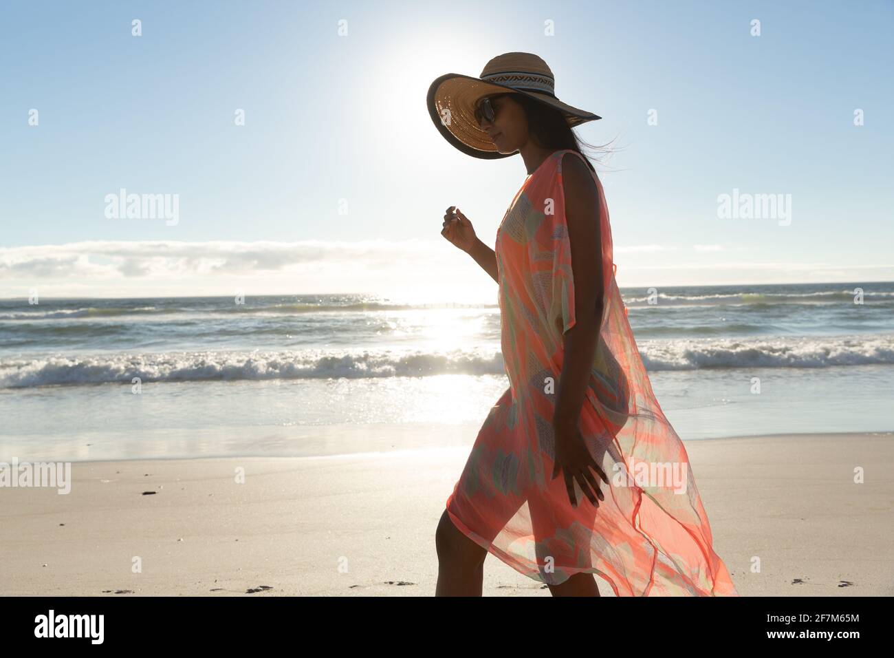 Bonne femme de course mixte sur la plage de vacances à pied Banque D'Images