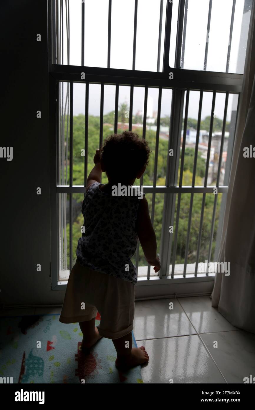 salvador, bahia / brésil - 14 octobre 2014: L'enfant est vu par une fenêtre avec une grille dans un appartement dans le quartier de Cabula dans la ville de Salv Banque D'Images