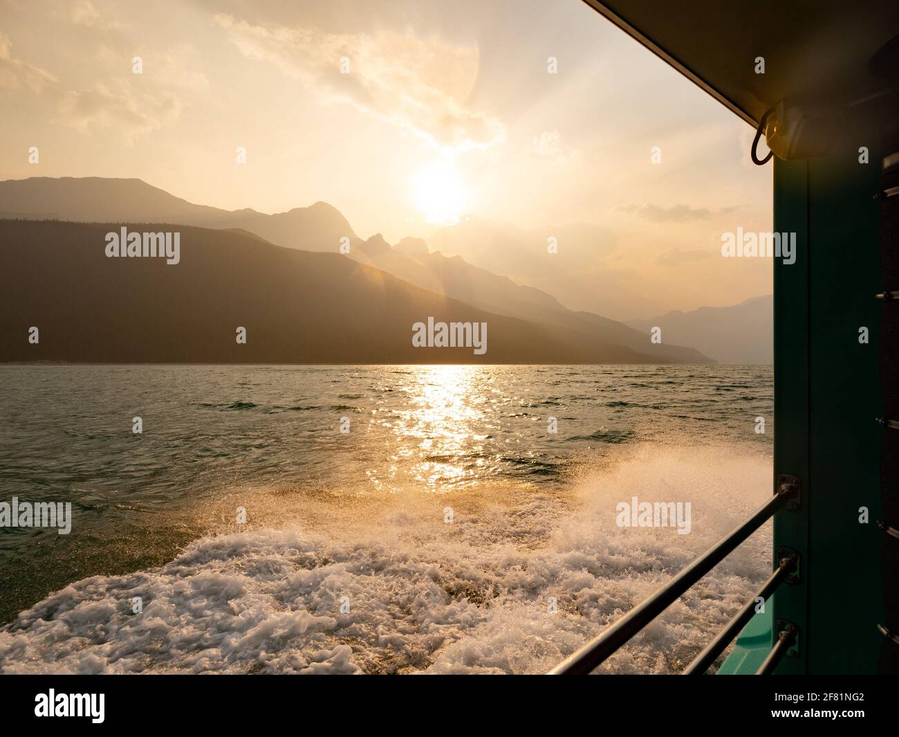 belle vue sur le coucher du soleil depuis un bateau sur un lac les rocheuses Banque D'Images