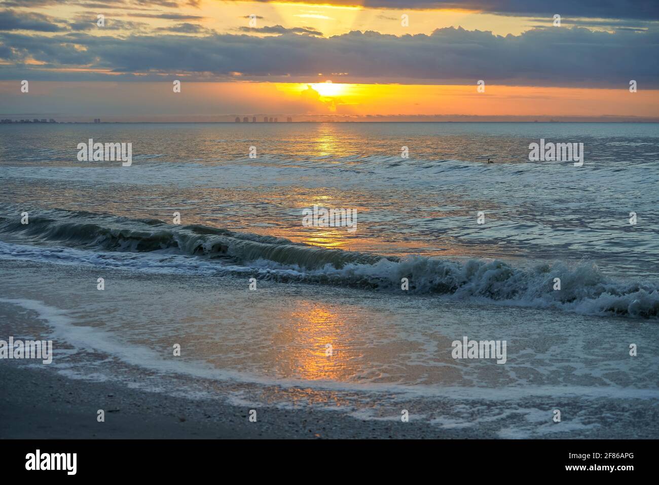 Soleil levant à travers les nuages sur l'île de Sanibel, Floride Banque D'Images