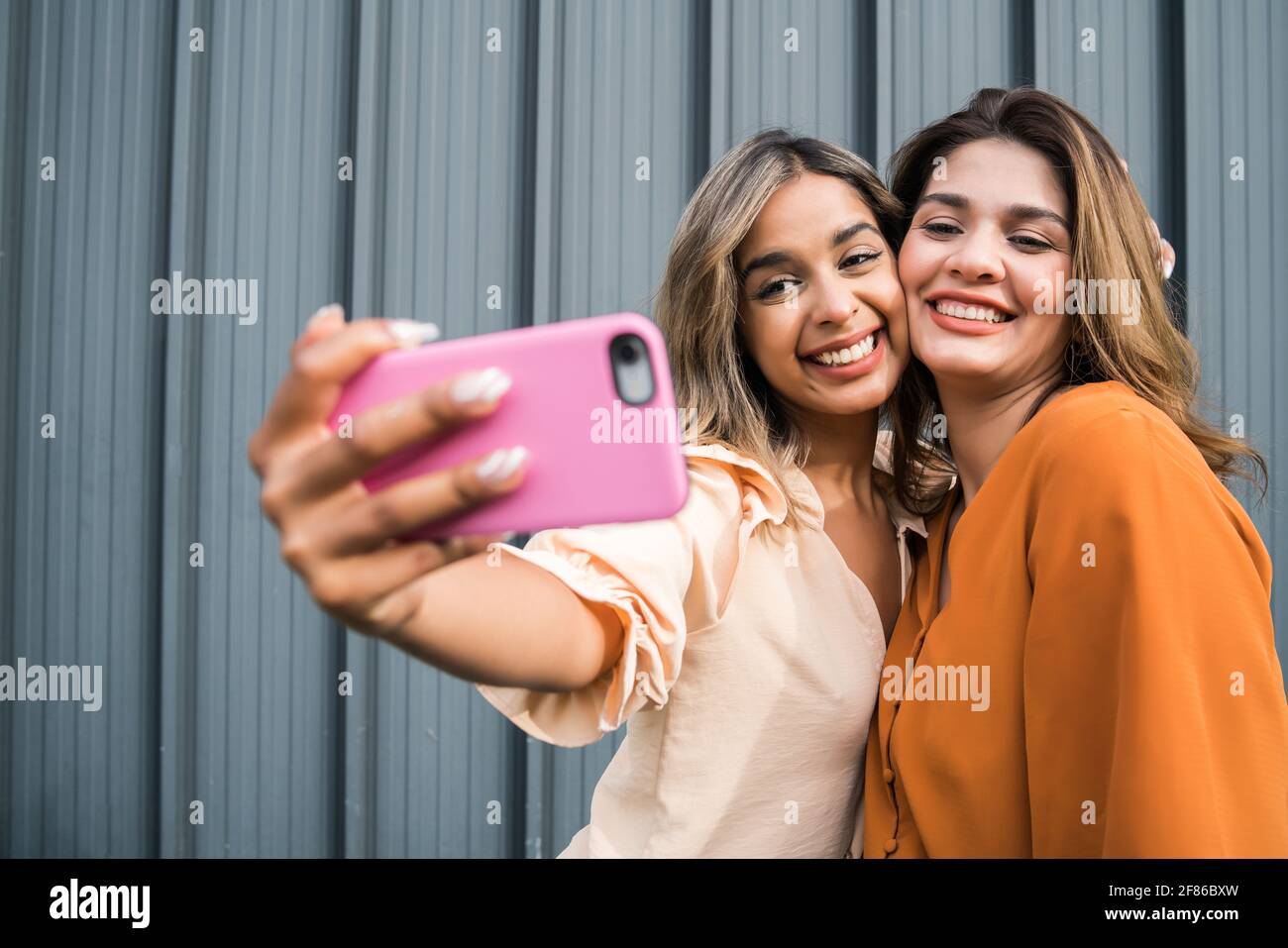 Deux amis qui prennent le selfie avec un téléphone à l'extérieur. Banque D'Images