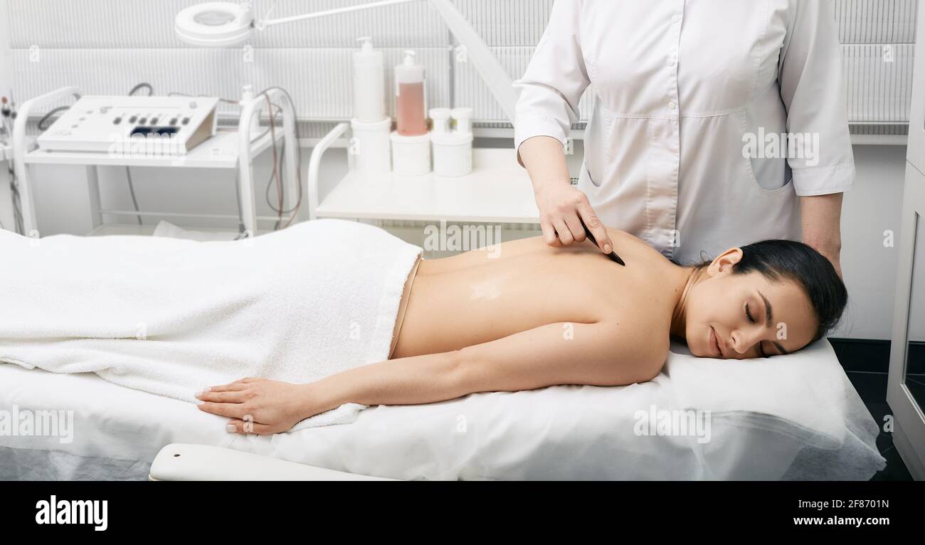 Gouache de massage chinois. Femme pendant le massage de gouache de dos pour  le corps détoxifier Photo Stock - Alamy