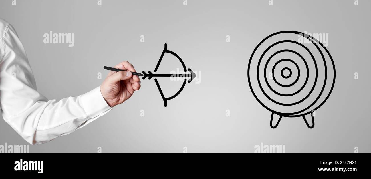 Main d'homme d'affaires avec un stylo dessine un arc et une flèche visant la cible. Réalisation d'objectifs dans la carrière ou l'entreprise. Banque D'Images