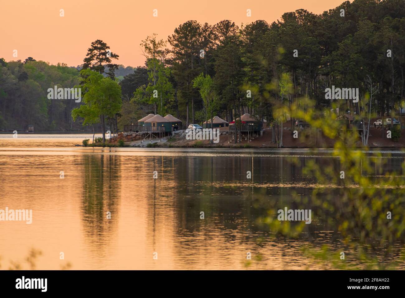 Des yourtes au bord du lac au coucher du soleil le long du lac Stone Mountain au terrain de camping Stone Mountain Park près d'Atlanta, en Géorgie. (ÉTATS-UNIS) Banque D'Images