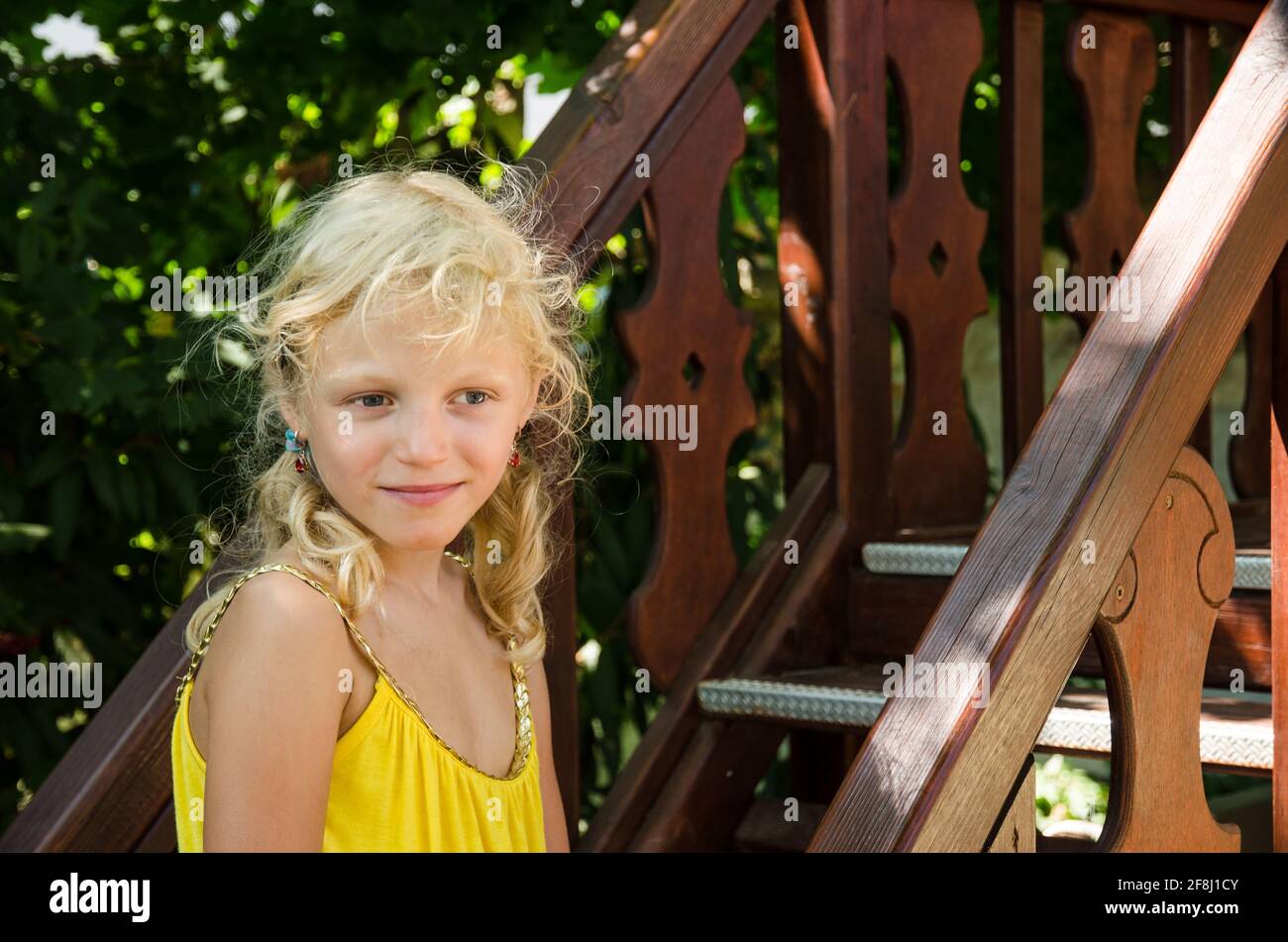 petite fille blonde en robe jaune portrait Banque D'Images