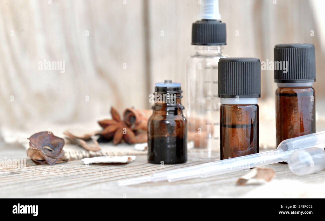 bouteilles d'huile essentielle et épices sur une table en bois avec pipeter pour extraire l'essence Banque D'Images