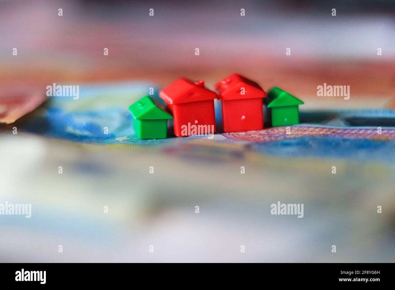 Tableau recouvert de billets en euros avec des maisons en haut. Concept d'investissement immobilier Banque D'Images