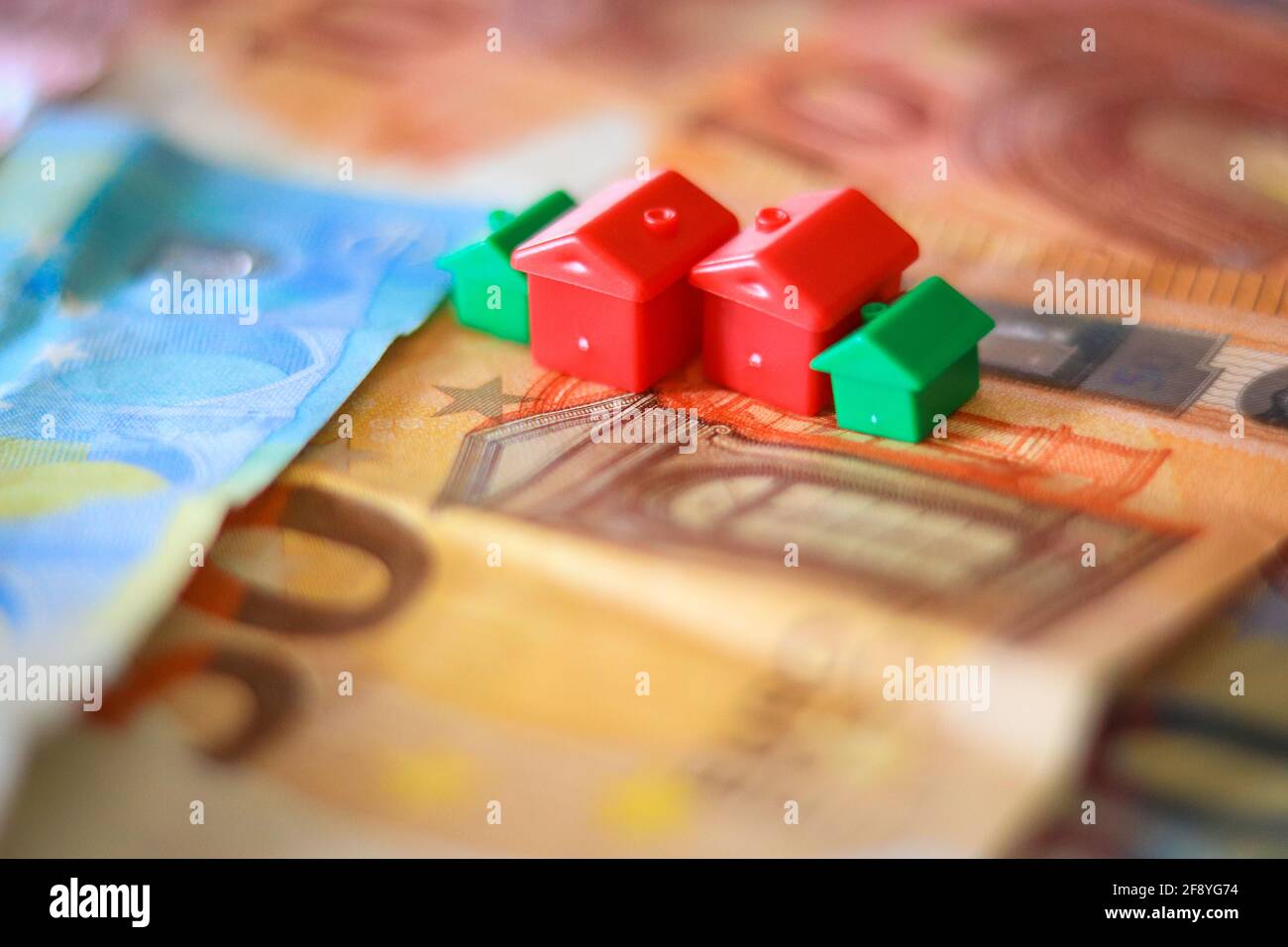 Tableau recouvert de billets en euros avec des maisons en haut. Concept d'investissement immobilier Banque D'Images