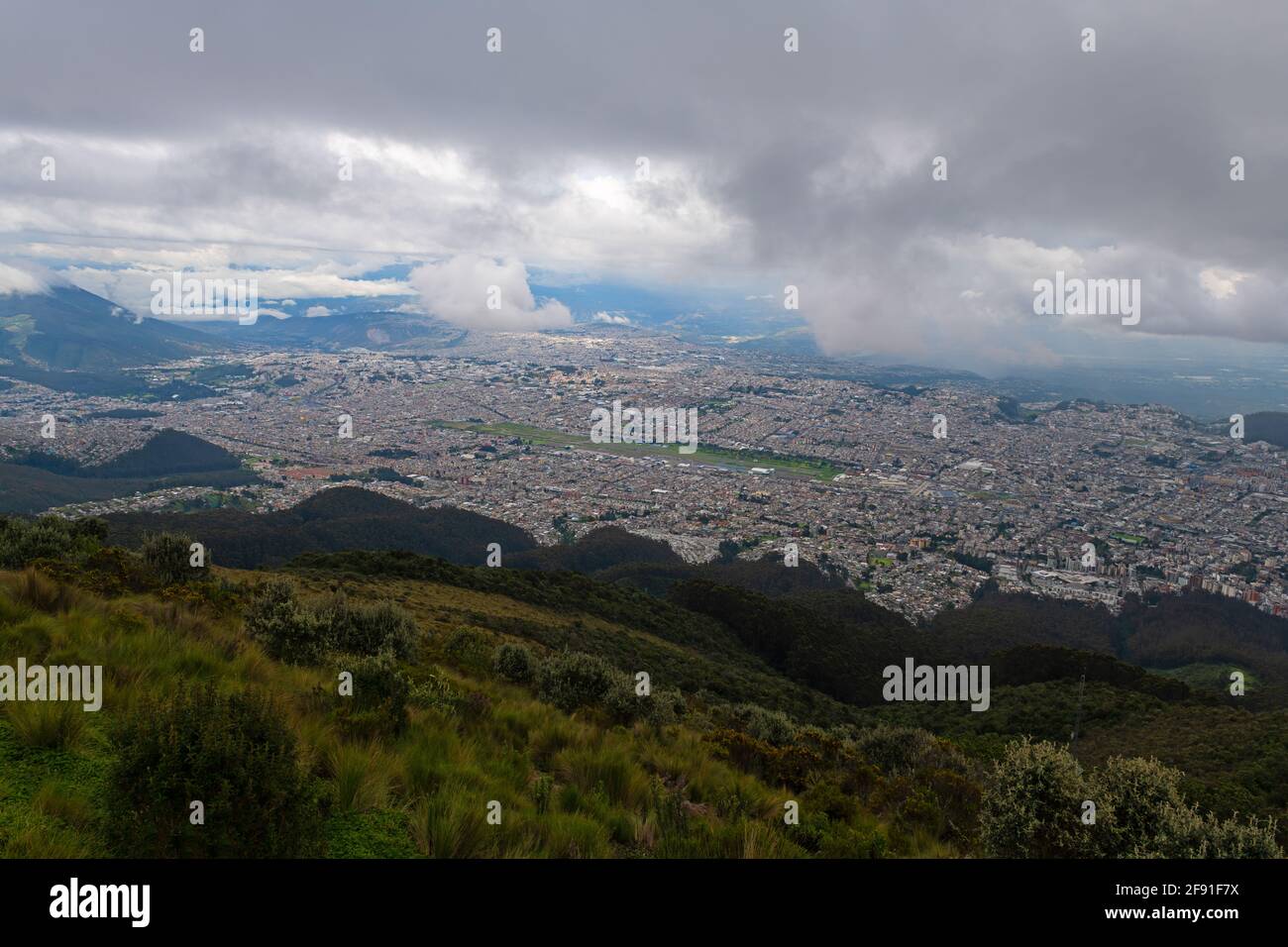 Paysage urbain sombre de Quito depuis le volcan Pichincha, Équateur. Concentrez-vous sur la ville. Banque D'Images