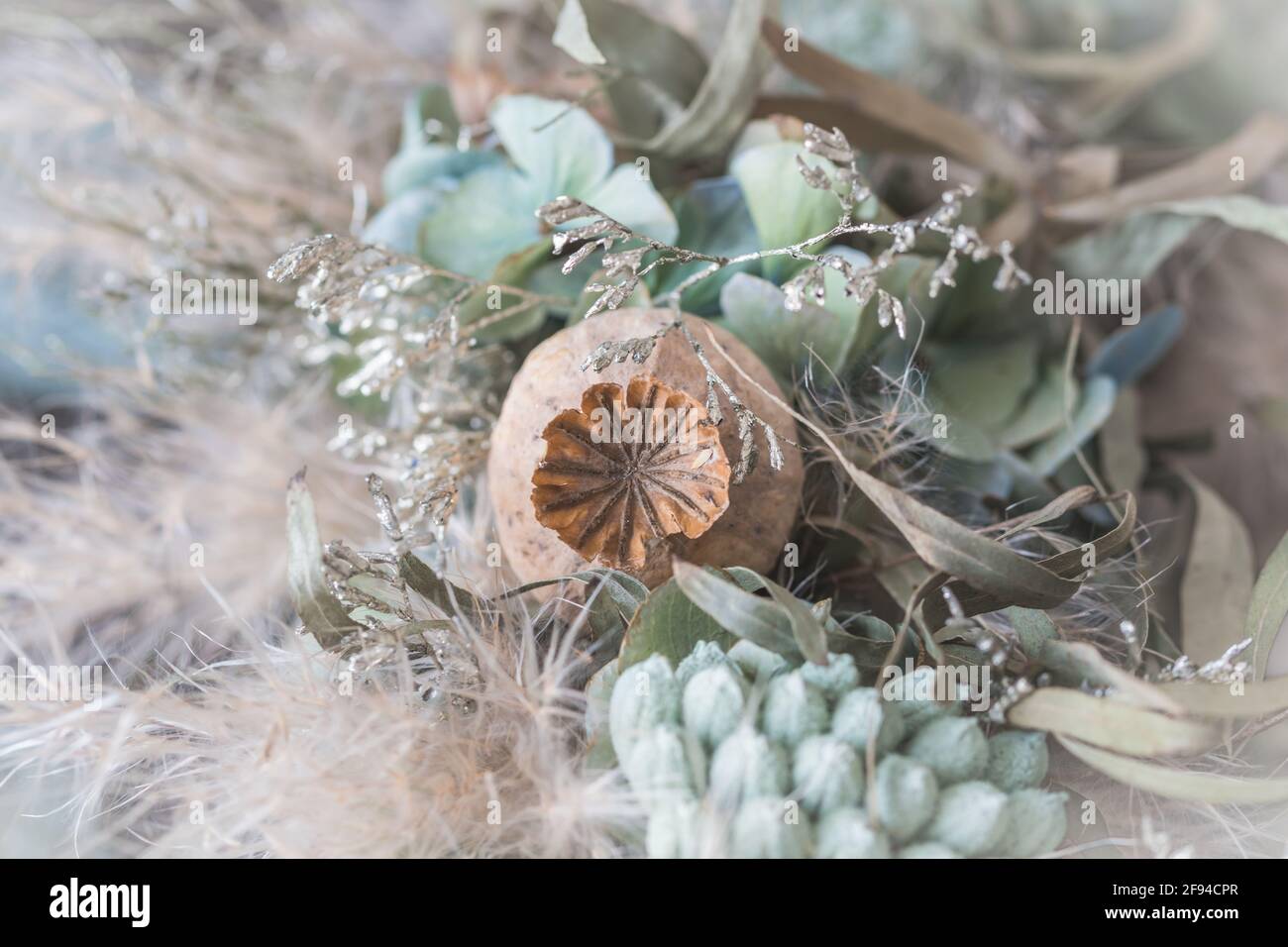 Gros plan d'une couronne de fleurs séchées en vert clair et couleurs d'hiver blanches Banque D'Images