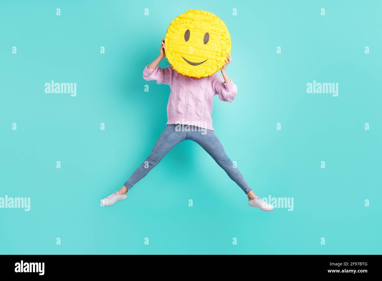 Photo pleine longueur de drôle funky jeune femme porte violet pull jumping  couvrir visage smiley isolé couleur turquoise arrière-plan Photo Stock -  Alamy
