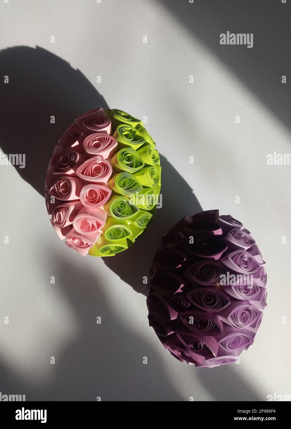 Deux œufs décorés de papier coloré en utilisant la technique de remplissage Banque D'Images