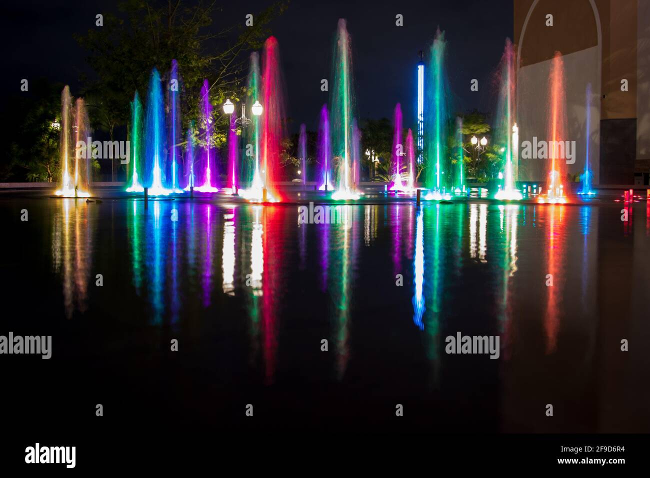 Longue exposition d'une fontaine extérieure colorée - eau et lumière se déplaçant à la musique - expérience unique de shopping à Merida, Mexique Banque D'Images