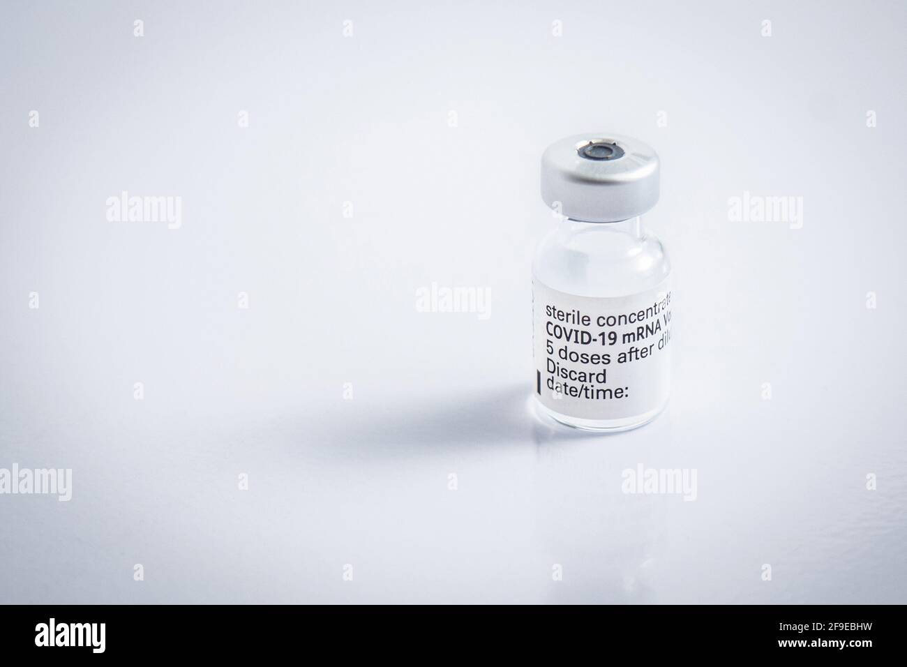 Gros plan d'un flacon avec le vaccin du coronavirus sur un arrière-plan blanc Banque D'Images