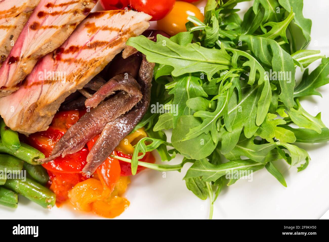 Délicieuse salade de thon grillé avec pommes de terre cuites au four et haricots verts recouverts de vinaigre balsamique. Macro. La photo peut être utilisée comme arrière-plan entier. Banque D'Images