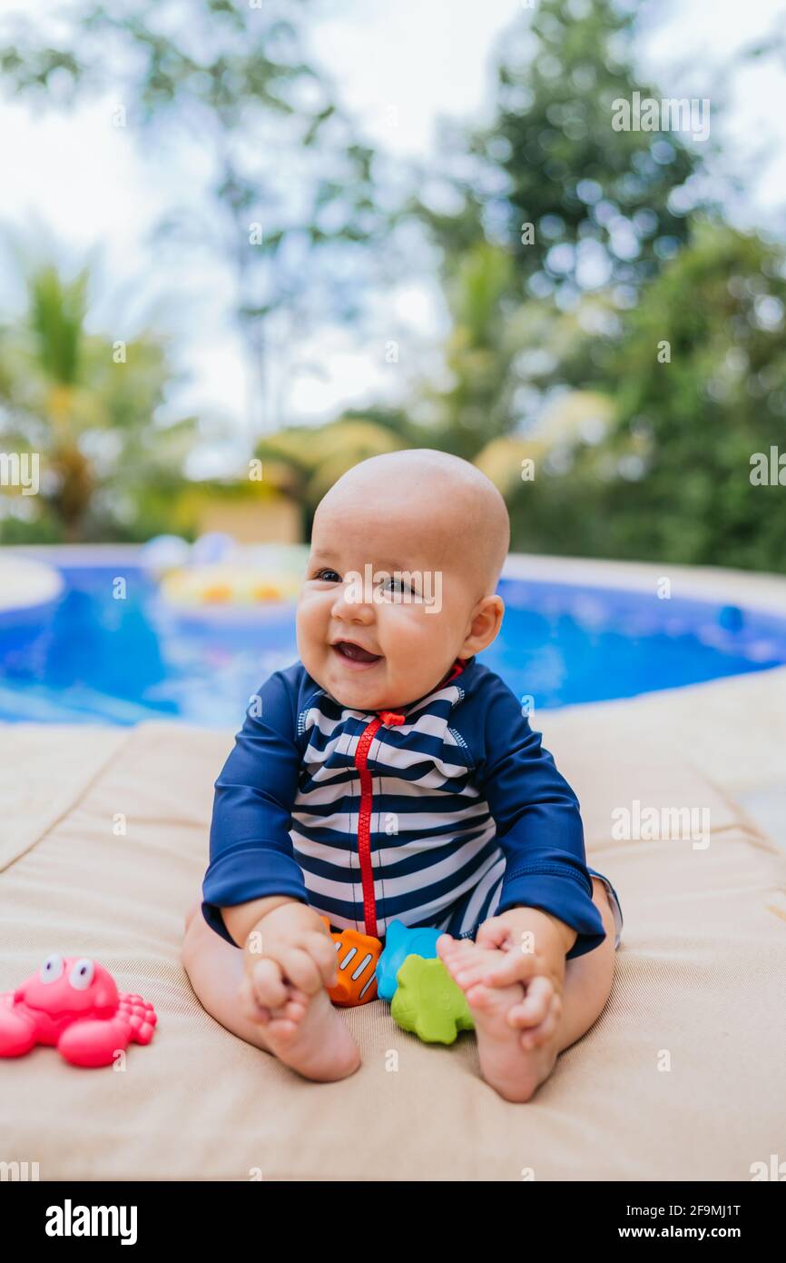 Mignon Petit Bebe Assis A Cote D Une Piscine Jouant Avec Un Jouet Photo Stock Alamy