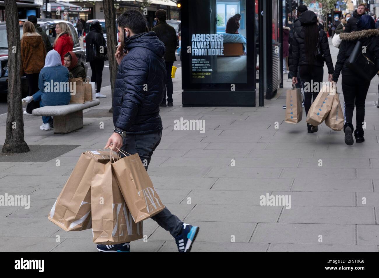 Les clients retournent à Oxford Street alors que les magasins non essentiels rouvrent et que le coronavirus national verrouille trois souks le 12 avril 2021 à Londres, au Royaume-Uni. Maintenant que la feuille de route pour sortir du confinement national a été établie, il s'agit de la première phase de l'assouplissement des restrictions, et un grand nombre de personnes sont sorties dans le quartier de détail de Londres chargé de sacs d'achats. Banque D'Images