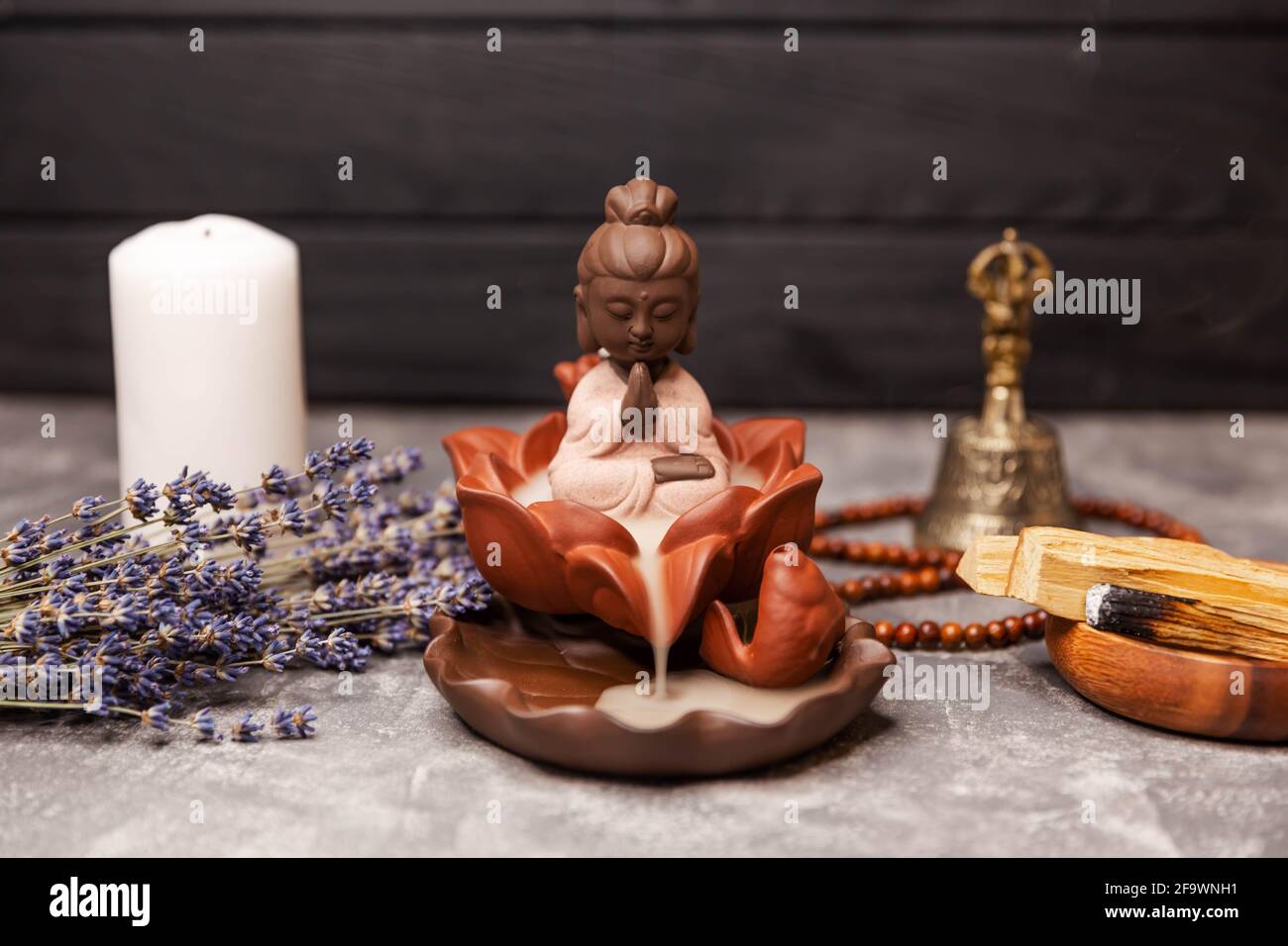 Concept religieux. Figurine de Bouddha avec fumée d'encens. Aromathérapie Banque D'Images